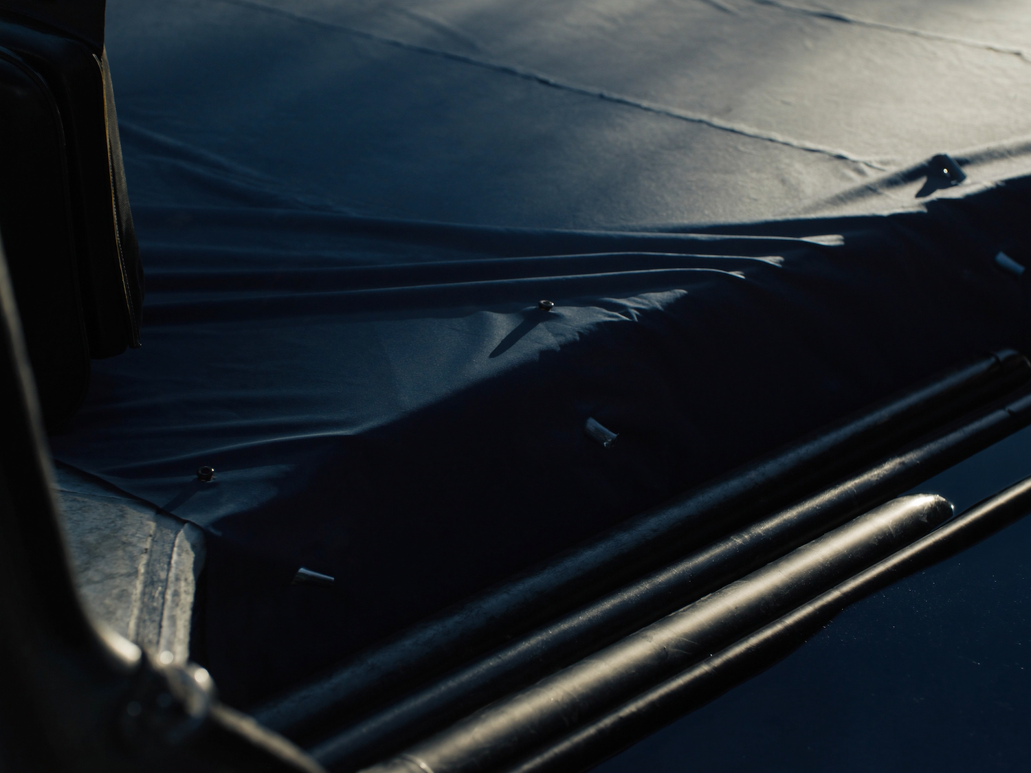 Winter safety cover being fitted over a residential pool