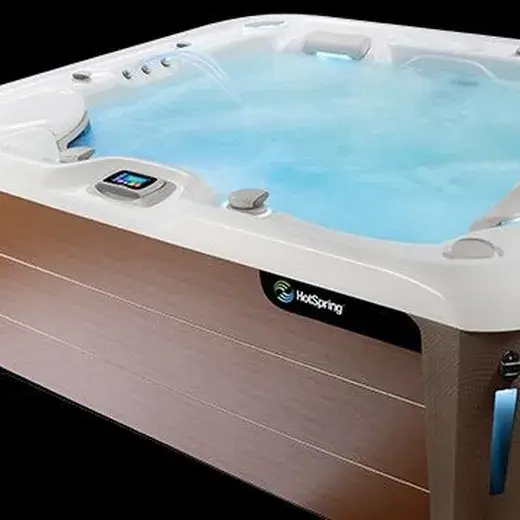 Hot Spring Highlife Collection spa with wood-tone cabinet
